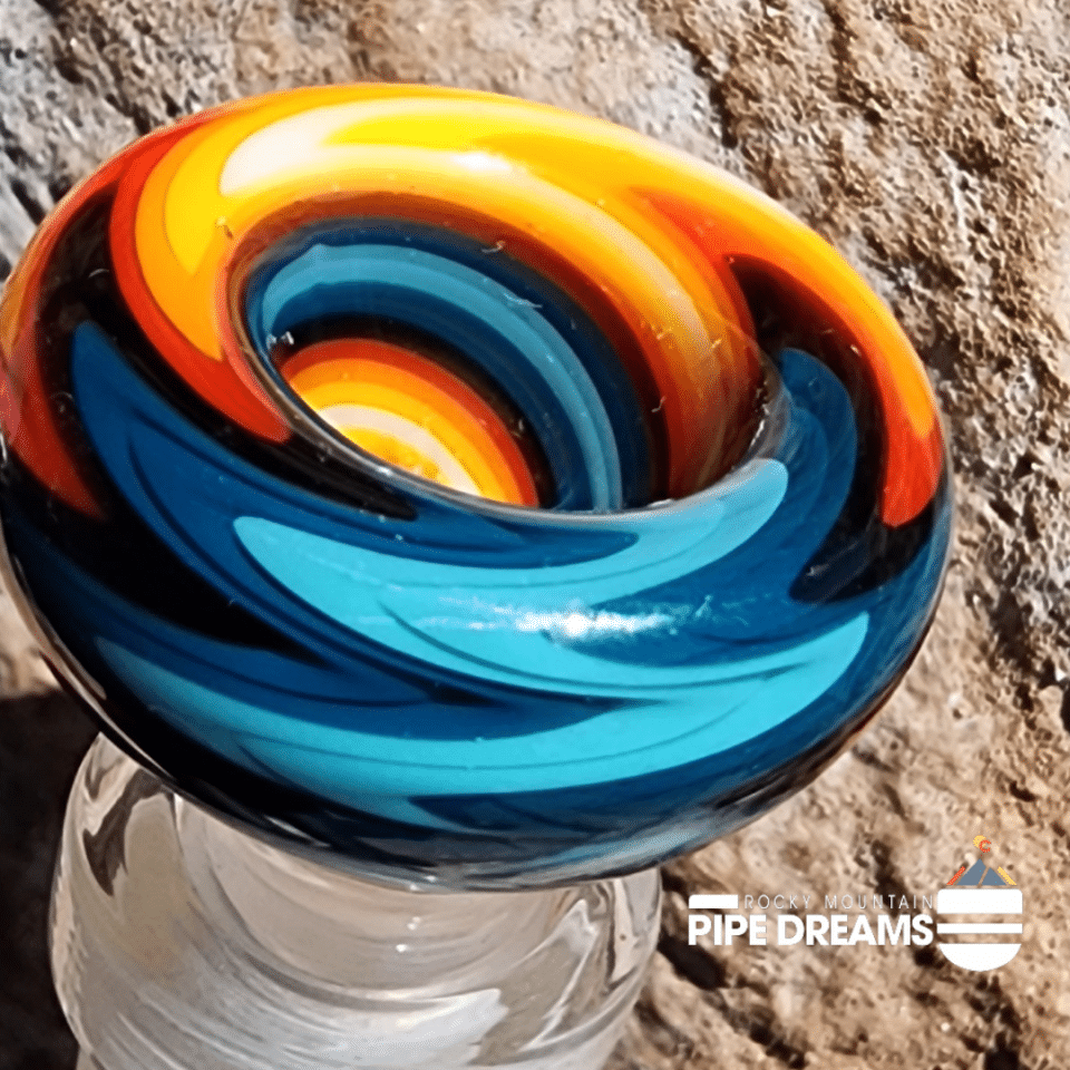 Blue thick glass with vibriant swirling colors of orange blue black light blue