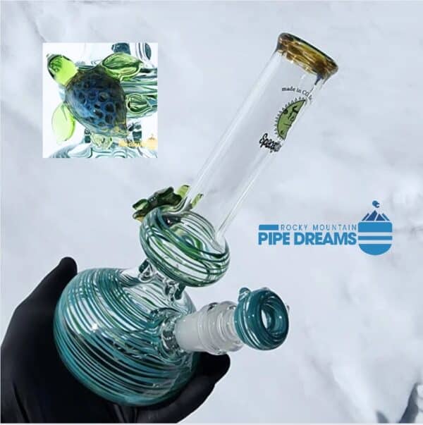 This turtle waterpipe by Spaceglass is 9 inches tall with a 5 inch base.. It has a 1 and a half inch scalpted turtle on the side mid way up the back of the water pipe color is green to blue color swirled and thick glass with weight.
