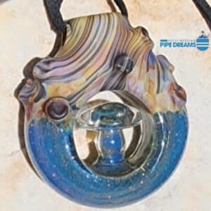 pendant made out of glass looks like woodgrain with wood knots and brilliant blue sparkled dicrotic glass 2 inch diameter