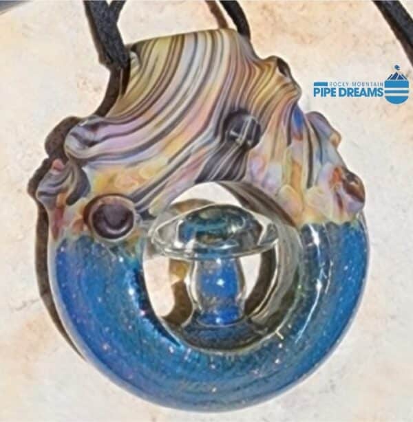 pendant made out of glass looks like woodgrain with wood knots and brilliant blue sparkled dicrotic glass 2 inch diameter