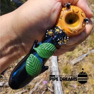 Glass hand pipe adorned with bumble bees, leaves and honeycomb