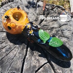 Glass hand pipe adorned with bumble bees, leaves and honeycomb